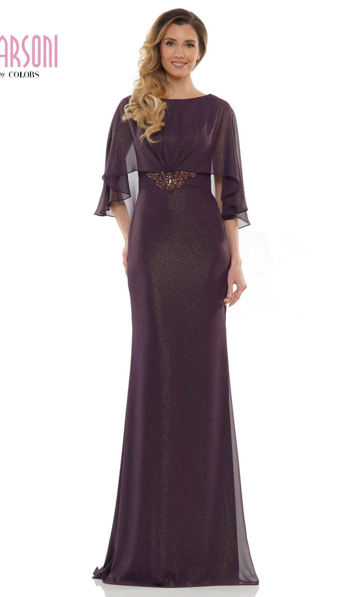 A woman wearing the Marsoni MV1130 long formal dress in eggplant, featuring sheer sleeves and a beaded waistband, stands facing forward.